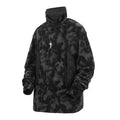 Black and grey tie dye printed men's turtleneck sweater with drop shoulders on a model.
