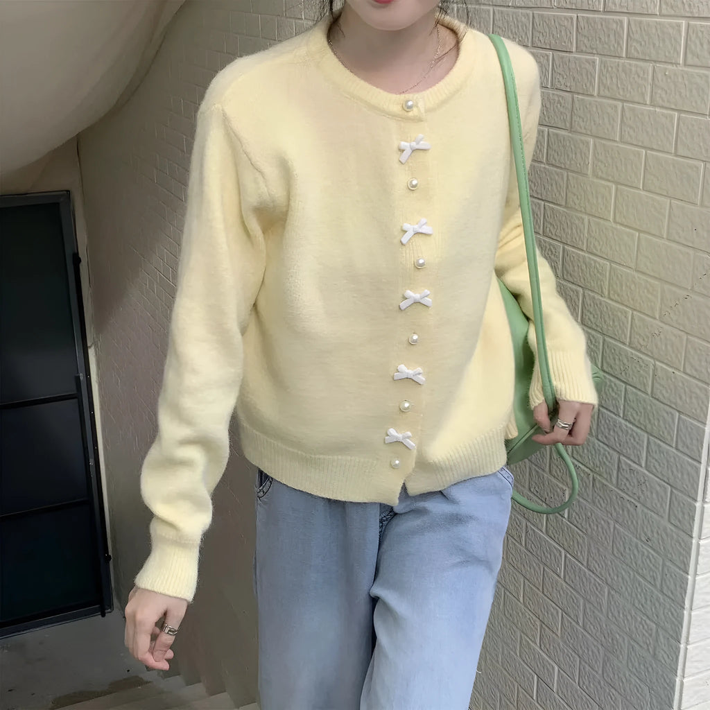 Women's acrylic cashmere cardigan sweater with bow and pearl button detail in nine colour options