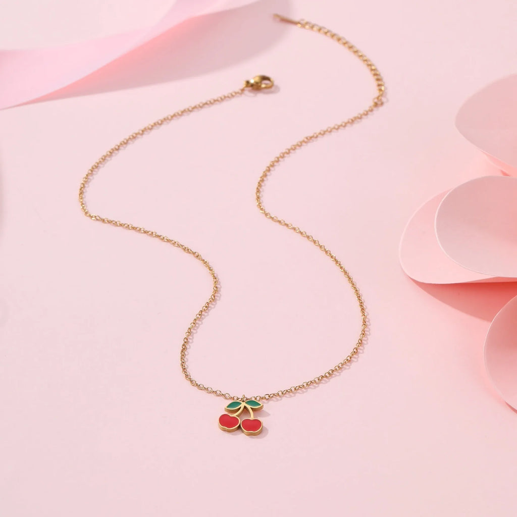 Cherry jewellery set showing necklace, bracelet, earrings, and ring with stainless steel construction and 18K gold electroplated finish