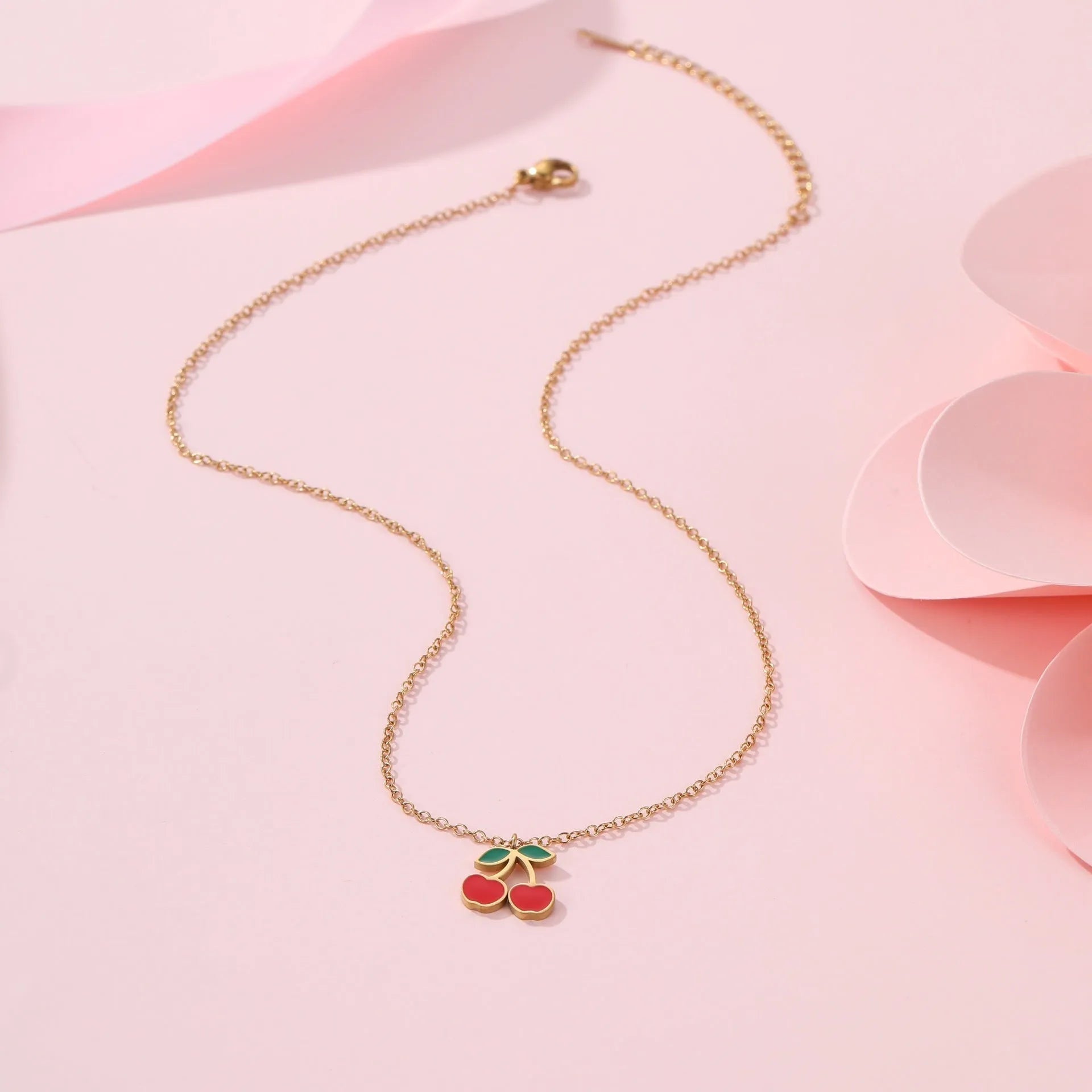 Cherry jewellery set showing necklace, bracelet, earrings, and ring with stainless steel construction and 18K gold electroplated finish