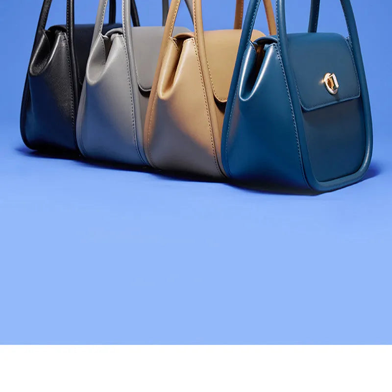 Women's leather wing-shaped tote bag with hard handle and cross-body strap in four colour options