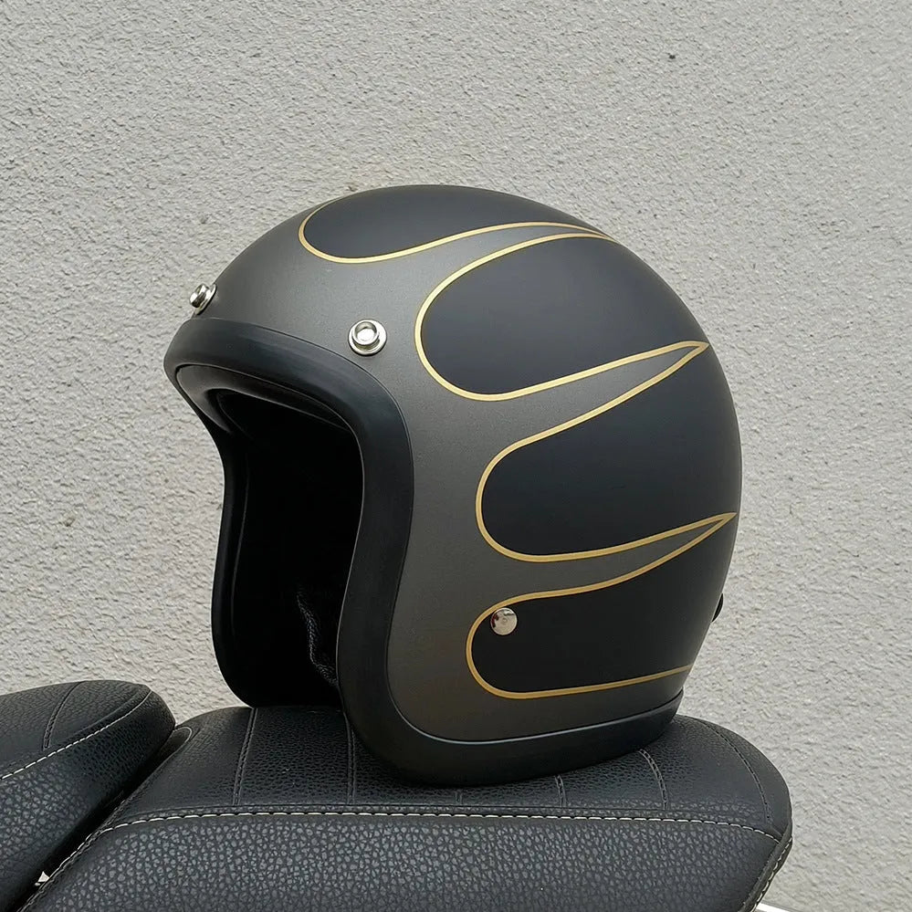 A cement grey retro-style motorcycle half helmet with a floral pattern on the side, showing its open-face design.