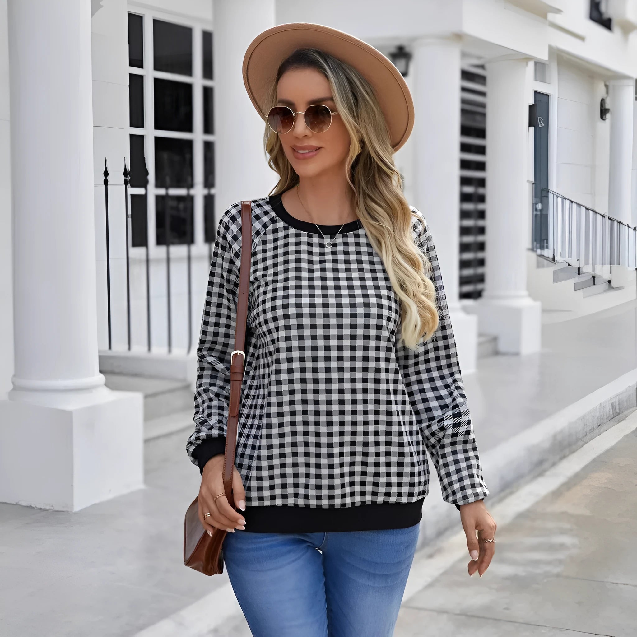 Black plaid and stripe pattern pullover sweater with long sleeves on mannequin