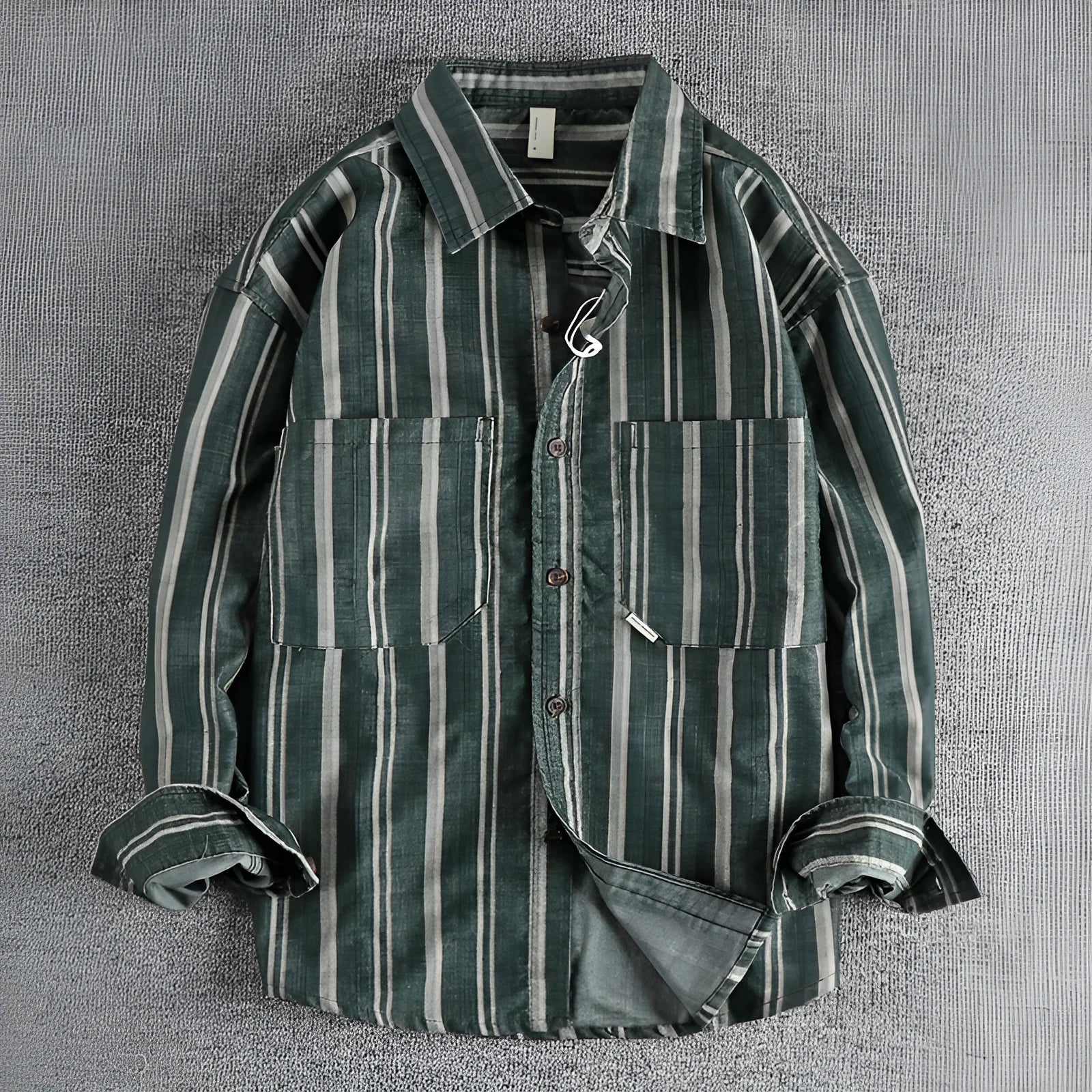 Man wearing a vintage-style striped overalls shirt in apricot colour with long sleeves and loose fit.