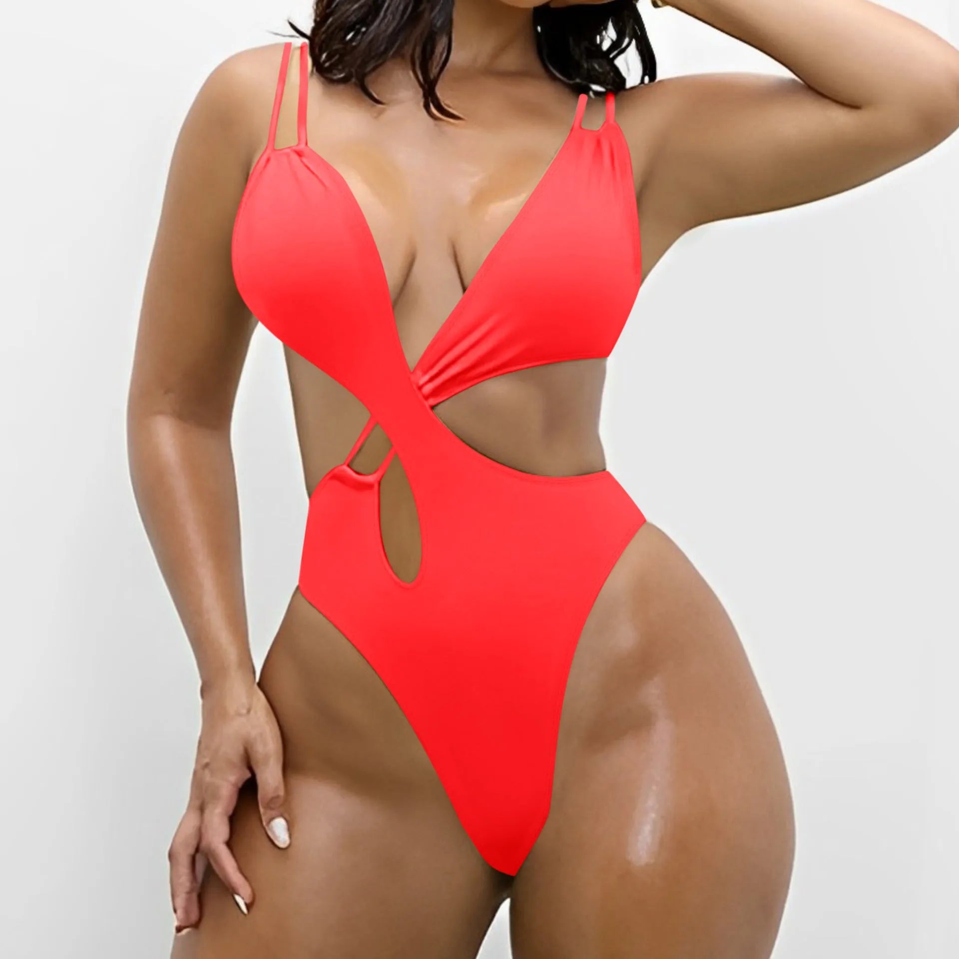 Women's solid colour one-piece triangle swimsuit in nylon, showing backless design.