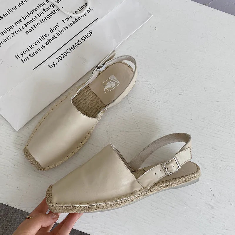 Women's beige retro-style canvas fisherman flat sandals on a light background