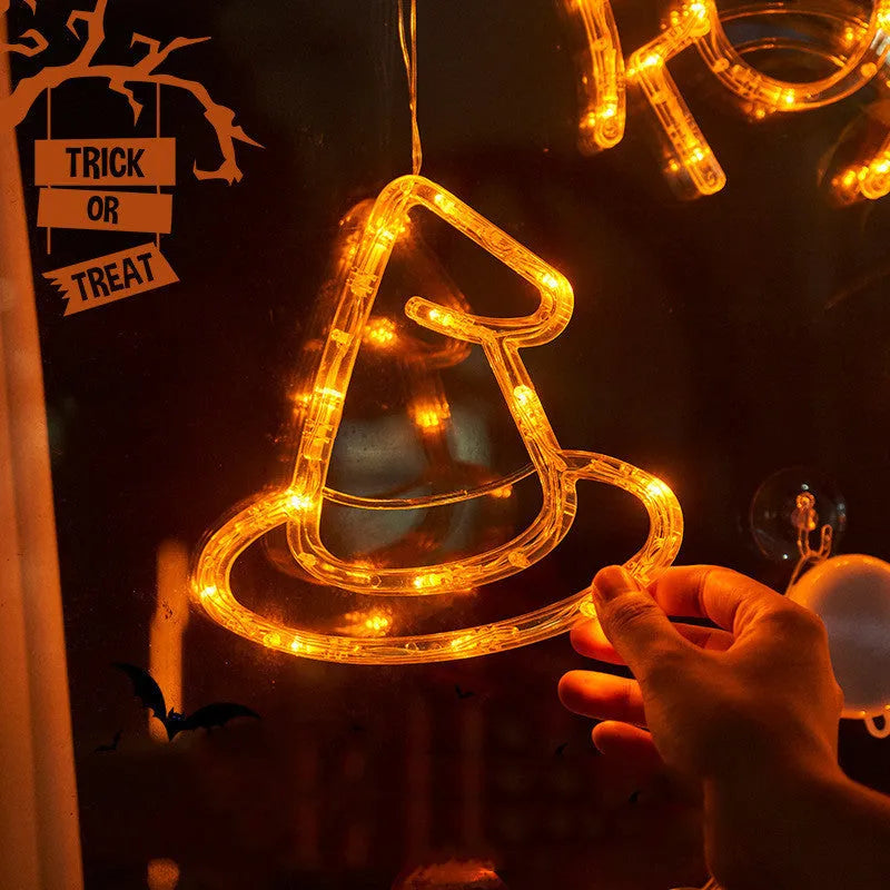 Seven Halloween LED lights with suction cups featuring spider, pumpkin and ghost designs for window decoration