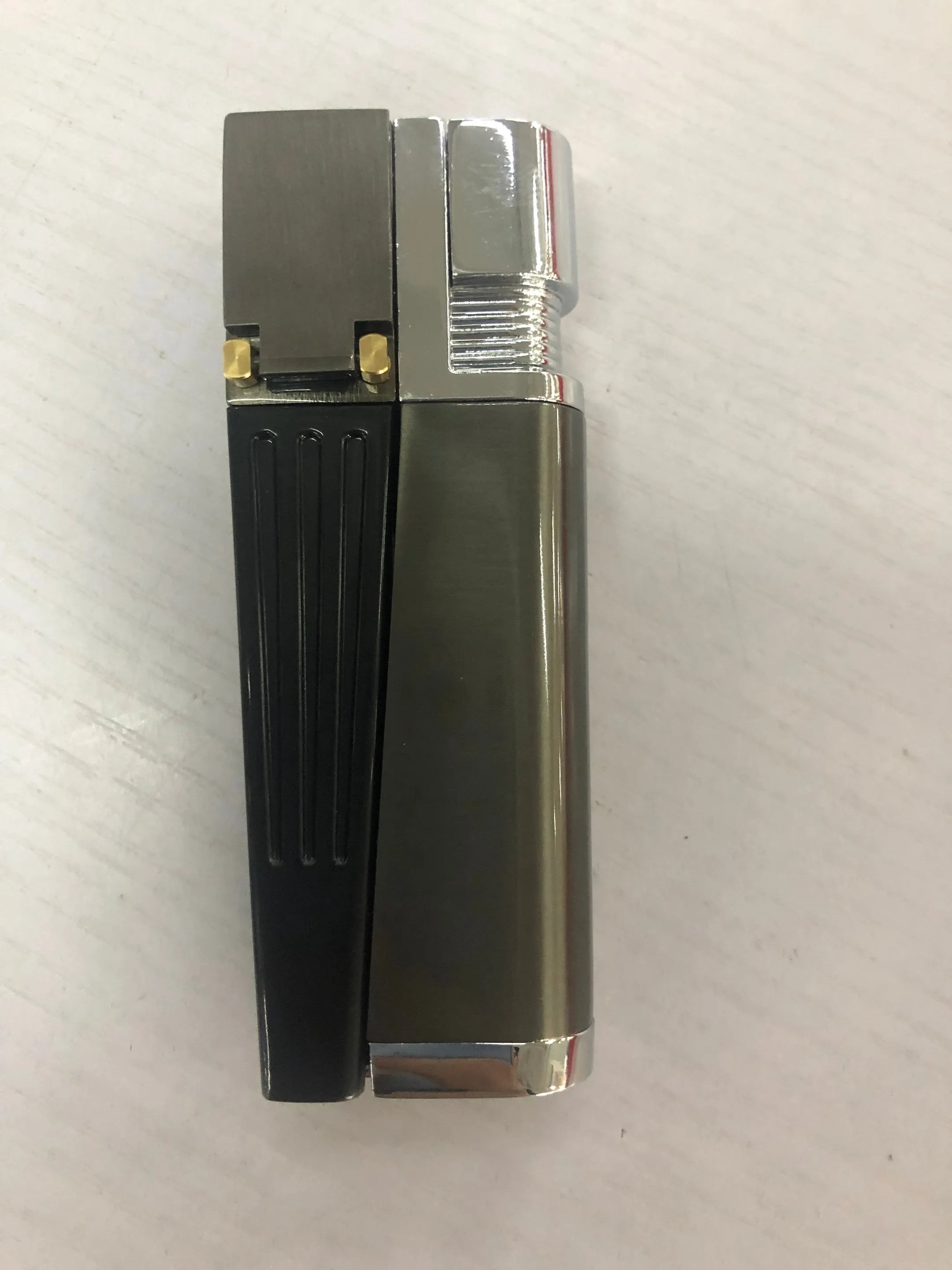 Silver and black foldable metal pipe lighter with stash compartment closed.