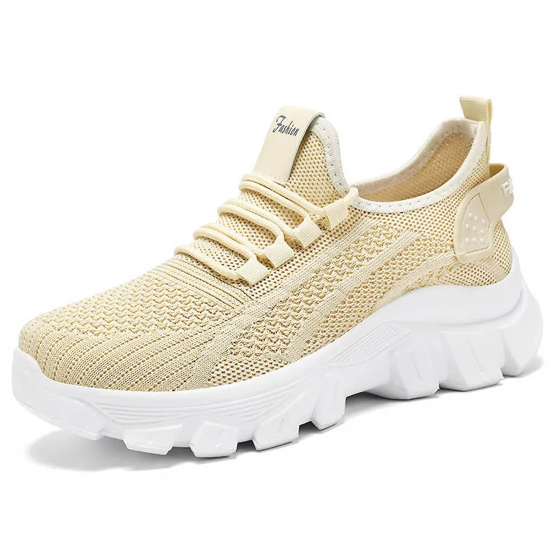Women's white Flyknit sneakers with a thick PVC sole and lace-up front.