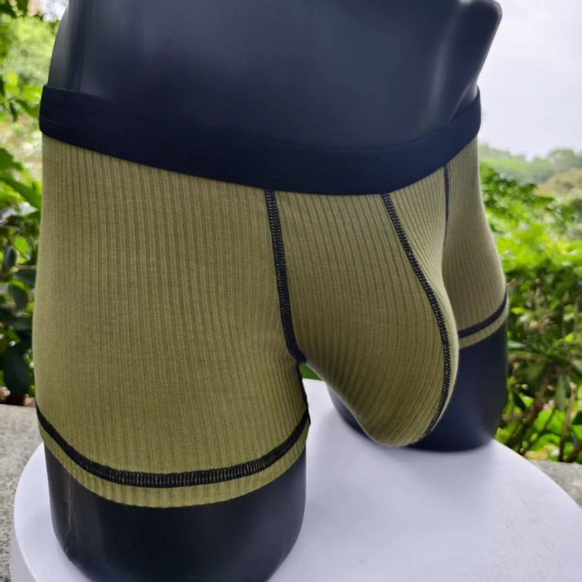 Solid colour men's boxer shorts in breathable fibre fabric, shown in Army Green.