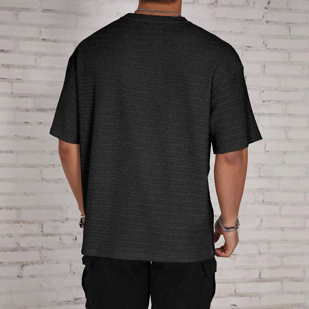 Men's loose fit light blue short sleeve round neck t-shirt on a hanger.