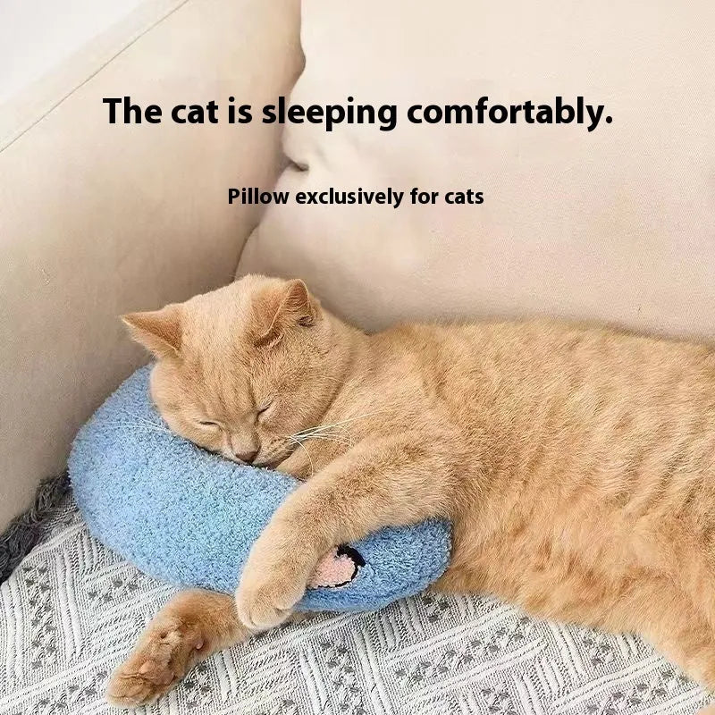 Blue U-shaped cat sleeping mat with moon design next to a yellow question mark shaped pet pillow.