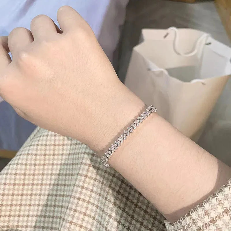 Silver plaid bracelet for women with moissanite stone on neutral background showing woven pattern and clasp