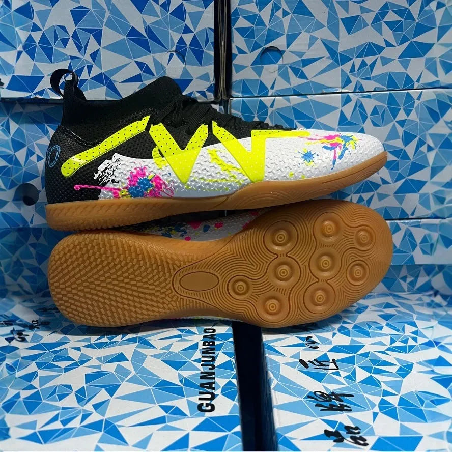 Men's black and yellow football boots with removable rubber studs on artificial grass
