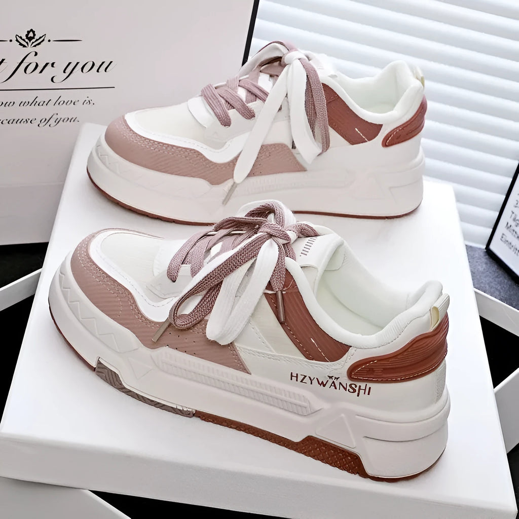 Children's beige platform shoes with thick rubber sole, lace-up front, and cross shoulder straps.