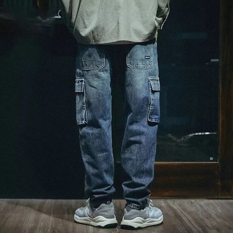 Blue men's loose straight-leg stretch denim trousers on a hanger