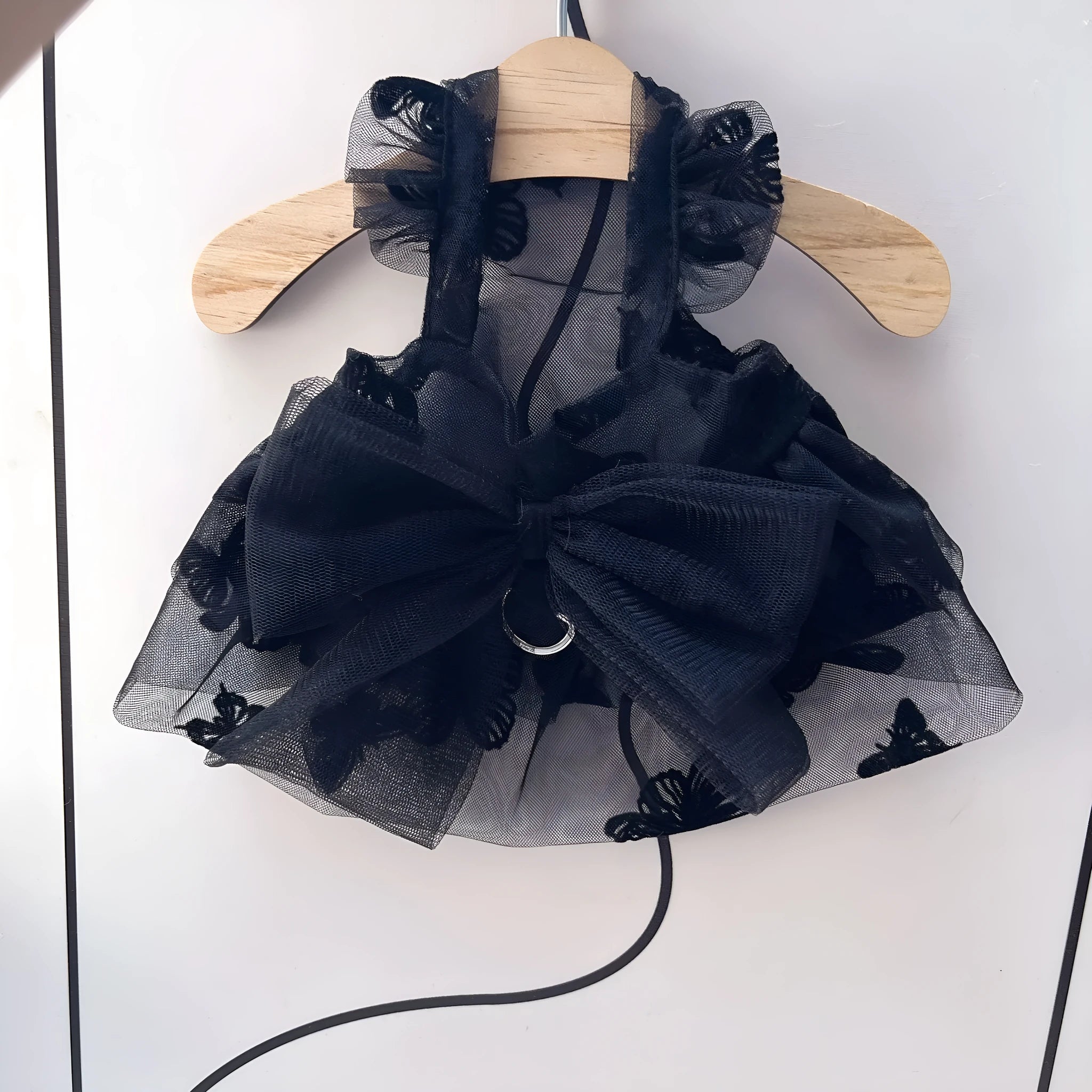 Black polyester tulle princess skirt costume for a small dog or cat on a mannequin, showing the gauzy fabric.