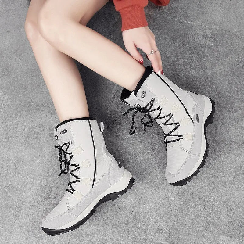 Women's black genuine leather mid-calf snow boots with round toe and rubber sole on a white background.