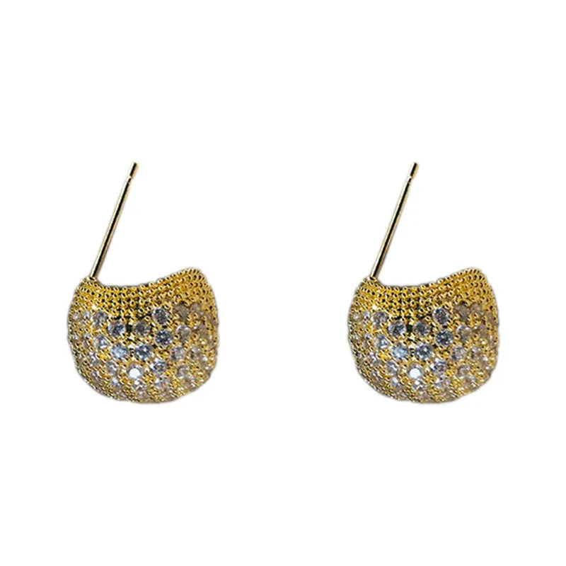 Gold and white geometric drop earrings with sparkling diamond-cut bean spheres.