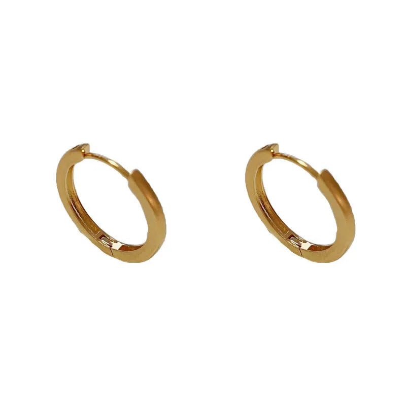 Women's geometric ear clips with round eyelet design in gold plating on copper