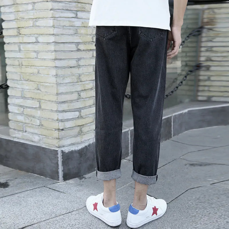 Men's loose straight leg harem jeans in black cotton denim with light straight leg opening