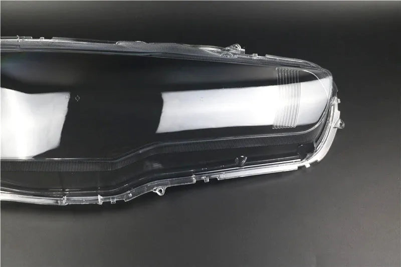 Transparent plastic vehicle headlight housing cover showing dimensions.