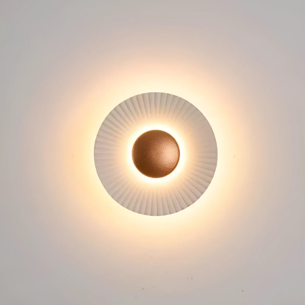 Round aluminium wall lamp mounted on a wall, showing a white and gold two-tone finish.