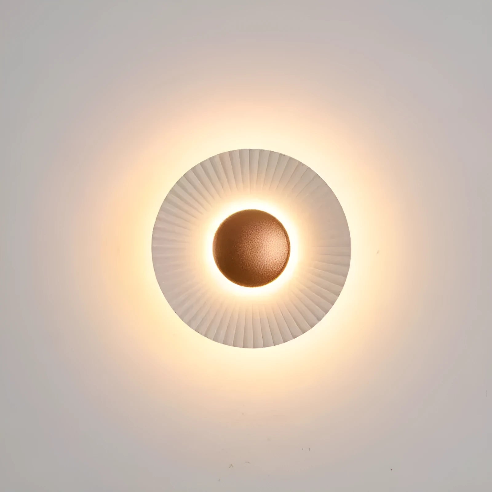 Round aluminium wall lamp mounted on a wall, showing a white and gold two-tone finish.