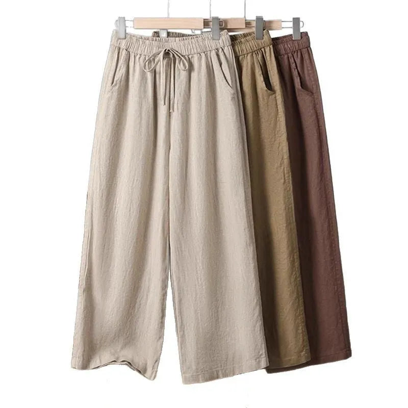 Women's apricot straight-leg casual trousers with elastic drawstring waist laid flat.