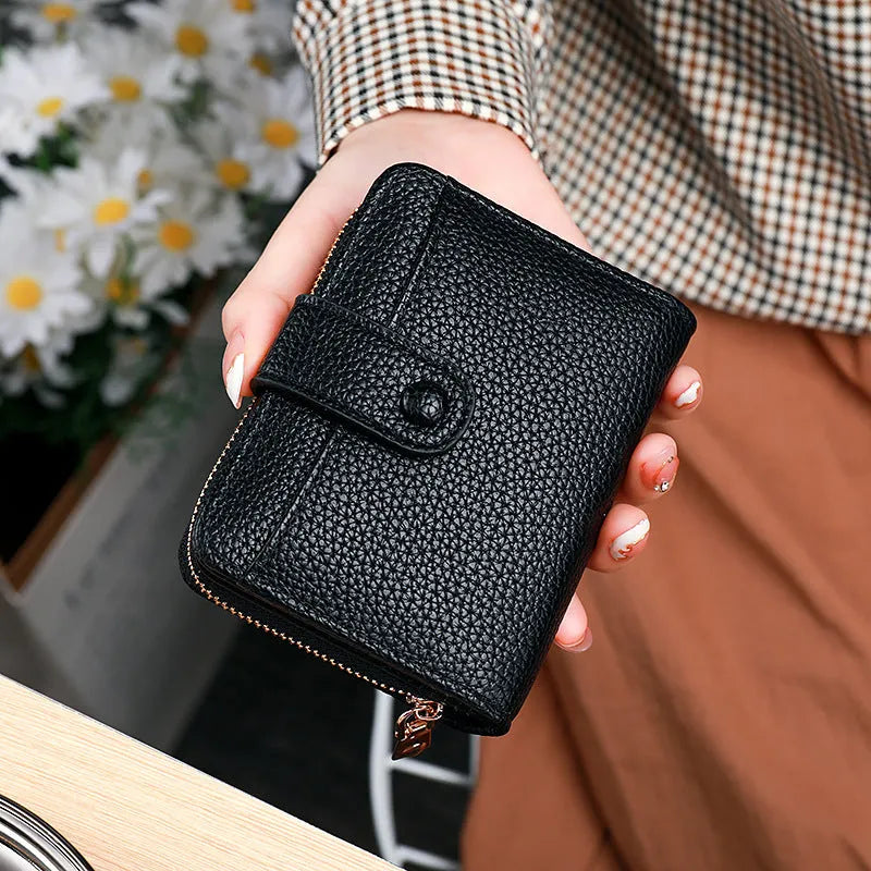 Women's lychee pattern short wallet in beige, pink, black, or red colours with decorative sewing thread detail.