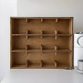 Square solid wood storage rack with multiple grid tiers in a natural birch wood finish.