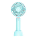 Blue mini handheld and desktop USB electric fan with oscillation on a table