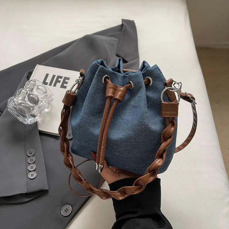 Blue synthetic leather cross body bucket bag with adjustable strap and sandwich pocket