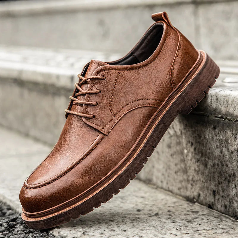 Men's black and brown casual leather shoes with round toe, low top, and flat rubber sole