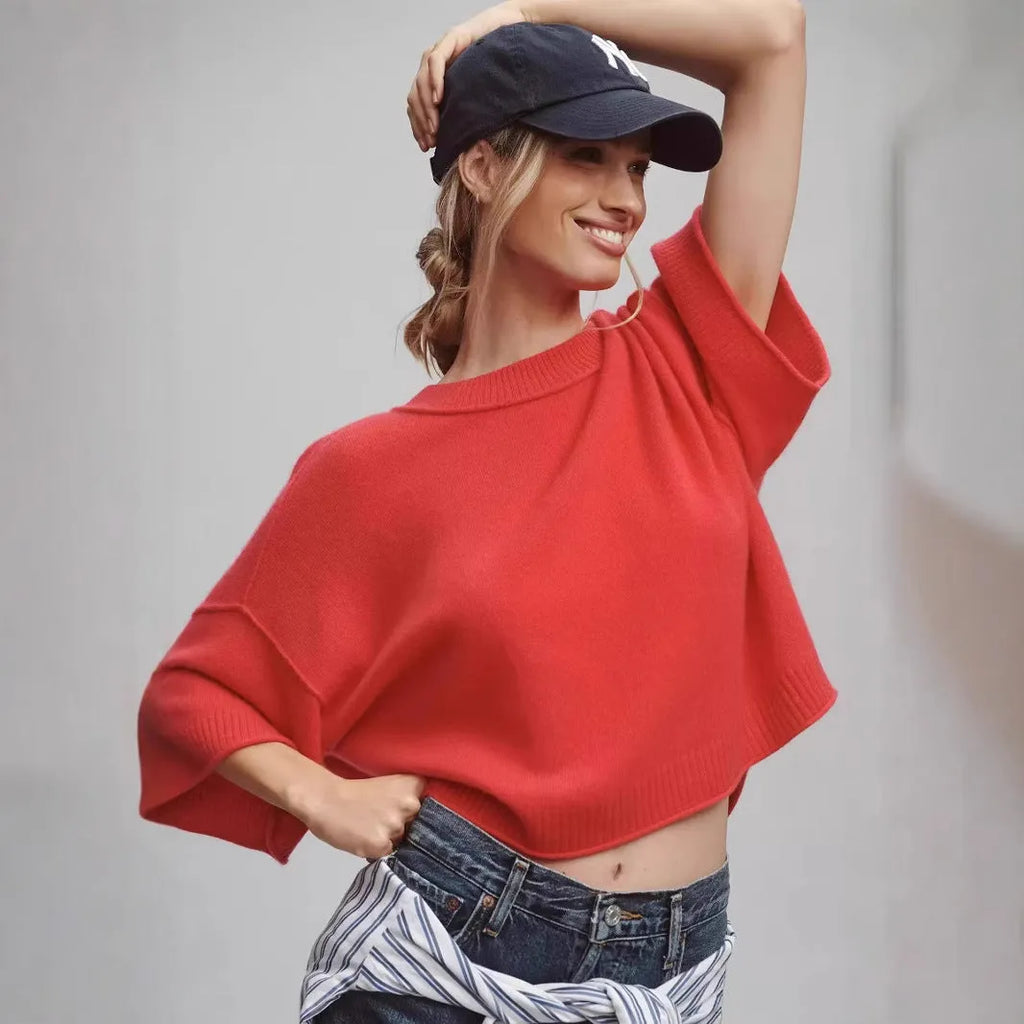 Red women's crop top t-shirt with regular sleeves on a hanger.