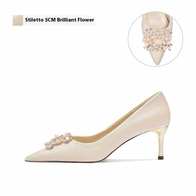 Rhinestone decorated pointed-toe bridal high heels on a white background.
