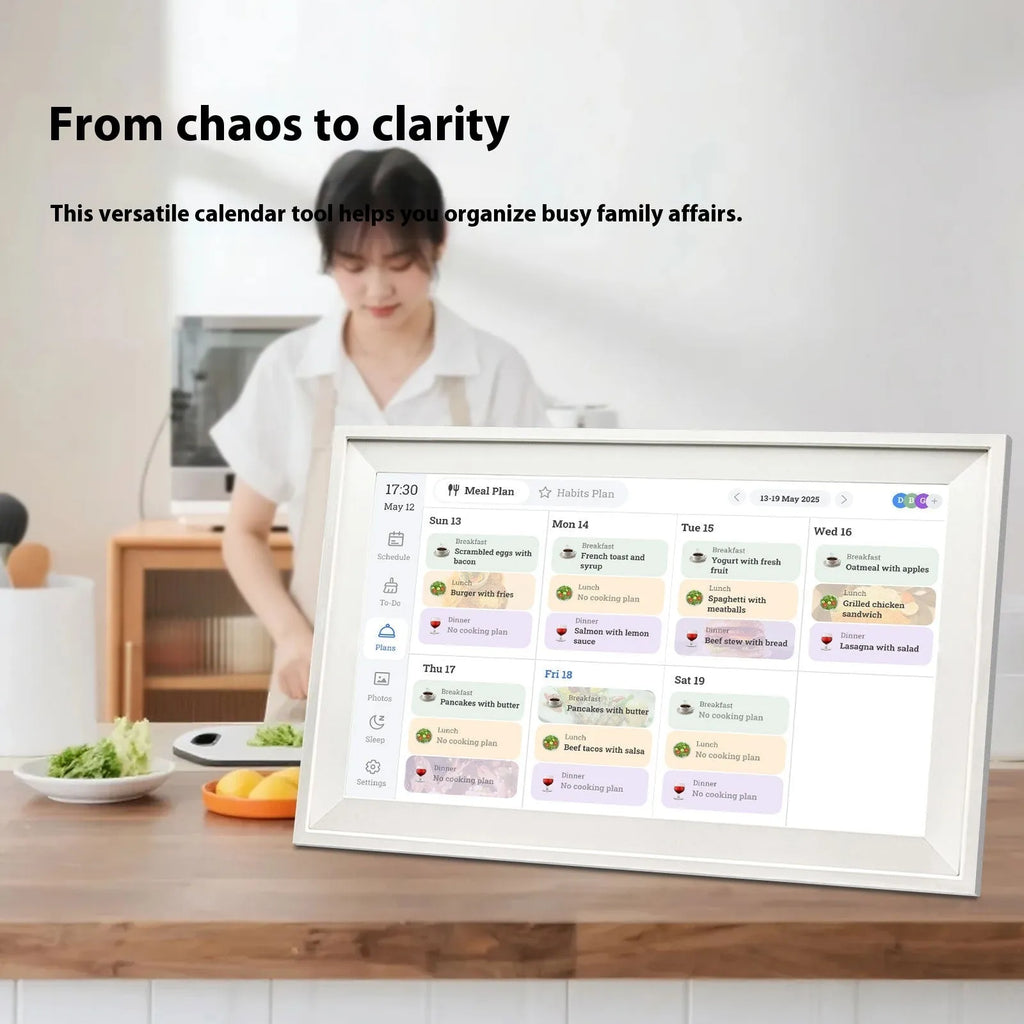 White smart digital photo frame with 15.6 inch screen on a table, showing a family photo.