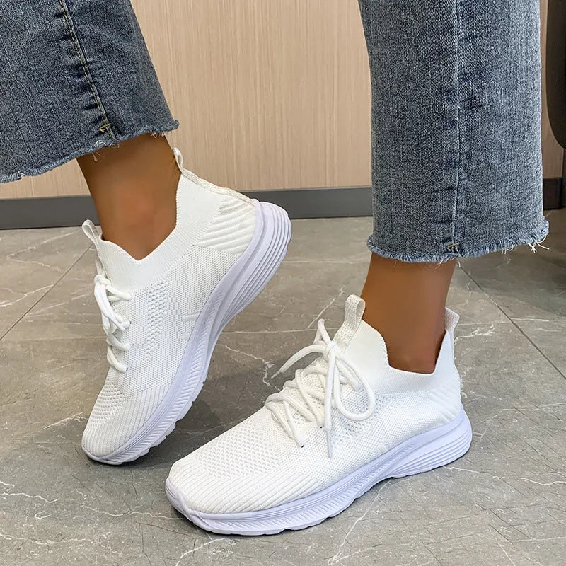 Women's mesh running shoes in Creamy White with Flyknit upper and low-top design