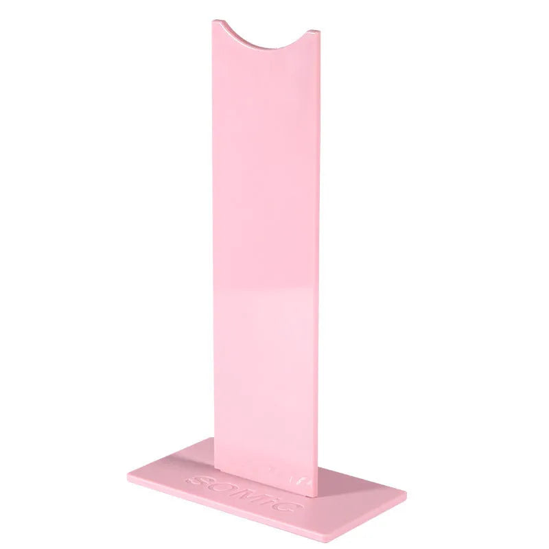 Pink and black detachable gaming headset stand on a desk with a non-slip silicone base.