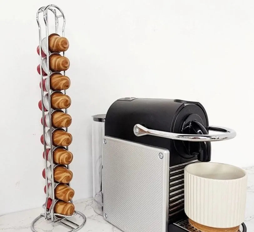Black iron coffee capsule storage rack holding pods on display shelves.