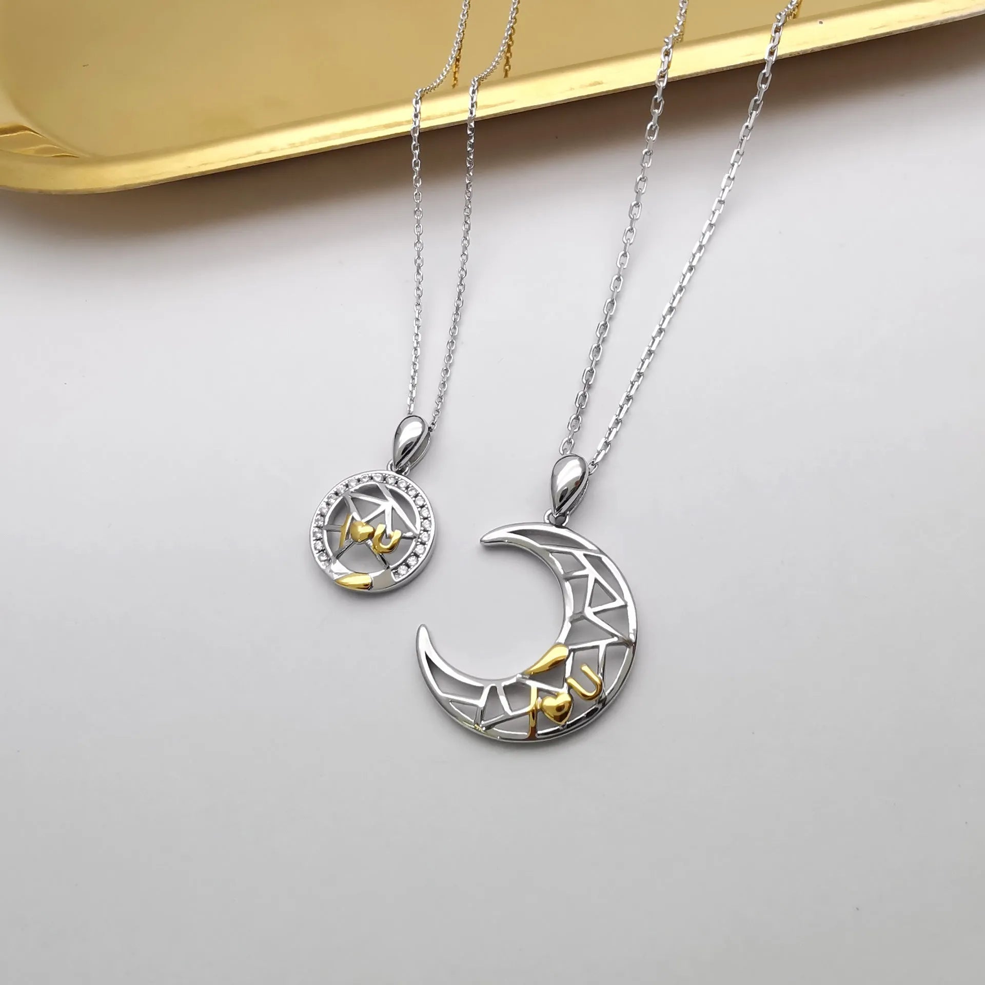 Sun Moon couple necklace set with copper electroplated pendants on a cross chain.