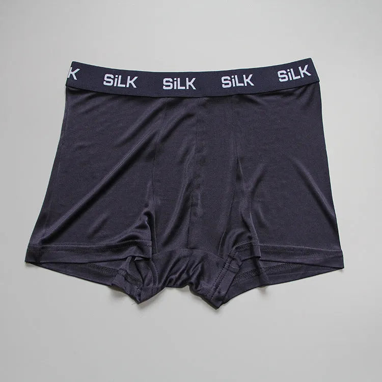 Men's loose silk shorts in navy blue, showing mid waist and relaxed fit.