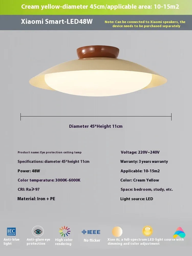 Modern cream-style flying saucer shaped ceiling lamp in a bedroom setting.