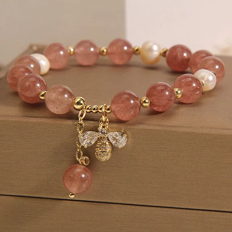 Women's strawberry quartz and freshwater pearl bracelet with zircon bee charm in Japanese-Korean jewellery style