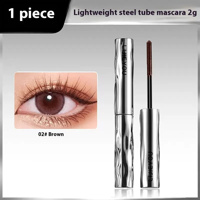 Waterproof steel tube mascara in black and brown shades shown with an eyelash curler.