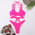 Women's solid colour bikini swimsuit on a hanger, showing adjustable straps and briefs style.