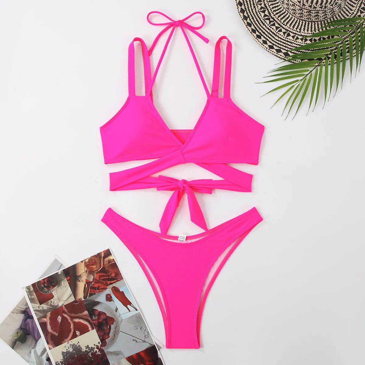 Women's solid colour bikini swimsuit on a hanger, showing adjustable straps and briefs style.