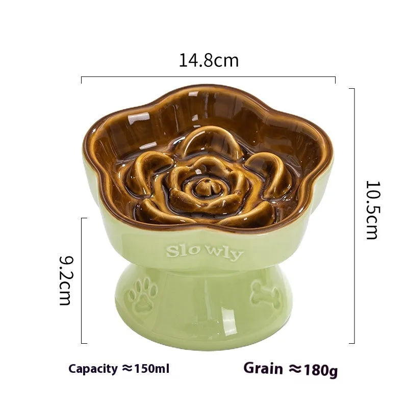 Black ceramic pet bowl with a chin-high foot and raised neck protector on a white background.