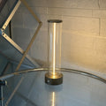 Grey modern LED line glass light strip with magnetic suction base for USB charging.