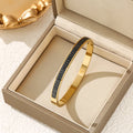 Electroplated titanium steel bracelet with round element in gold purple finish